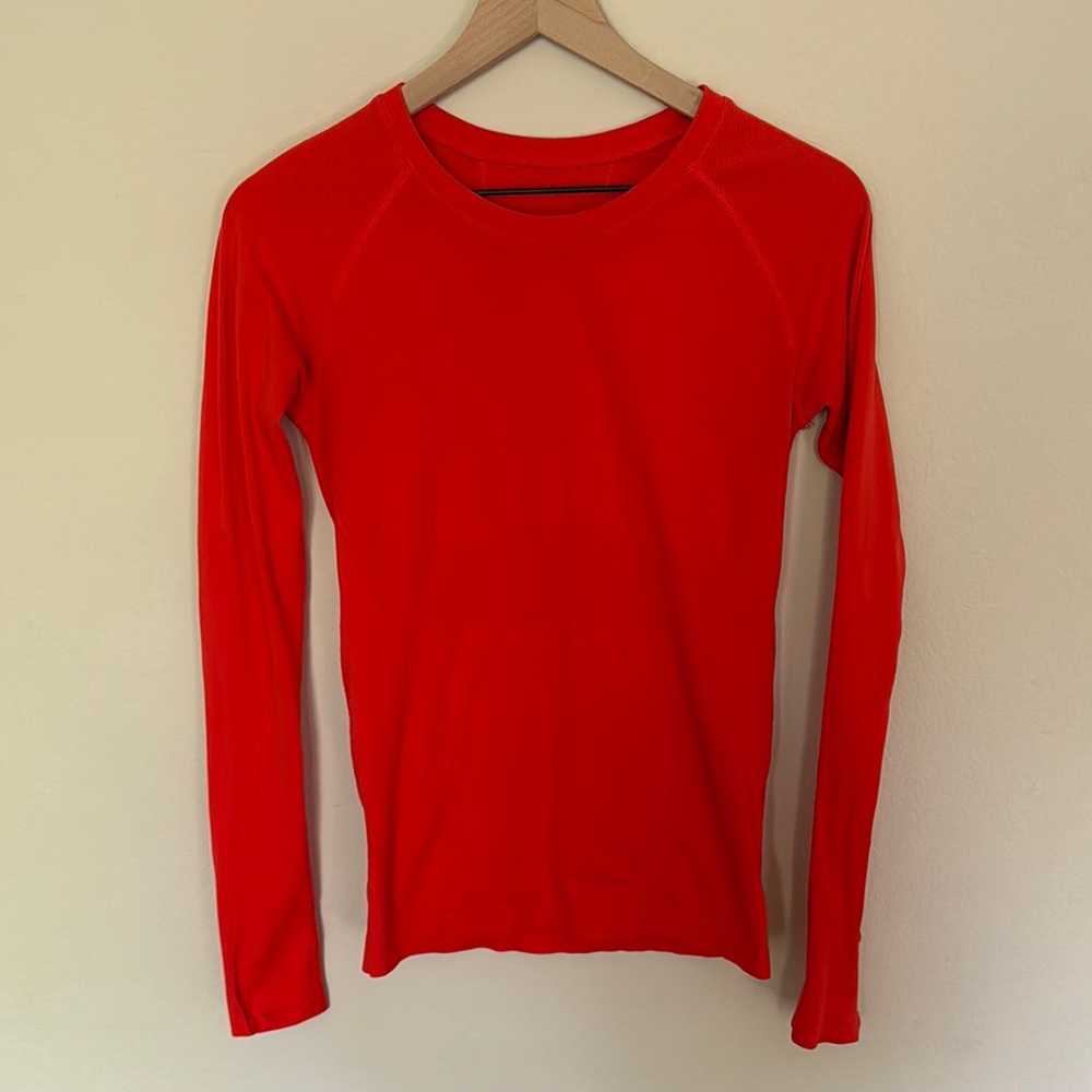 Athleta orange-red long-sleeve athletic top